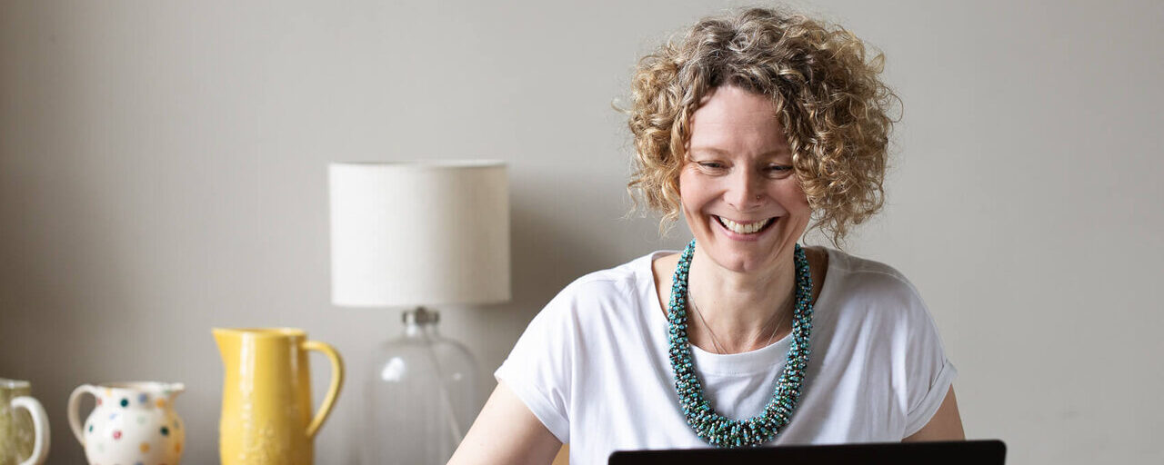 Kate Houldsworth writing at the dining room table